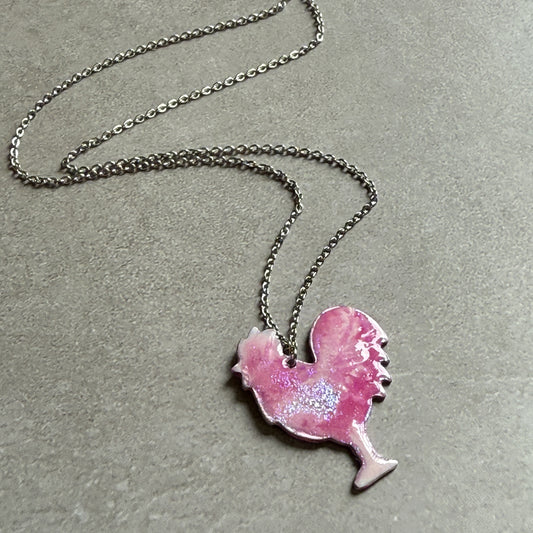 Necklace with a pink rooster-shaped pendant on a gray background